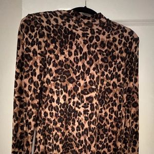 High neck long sleeve back zip top. Leopard color.